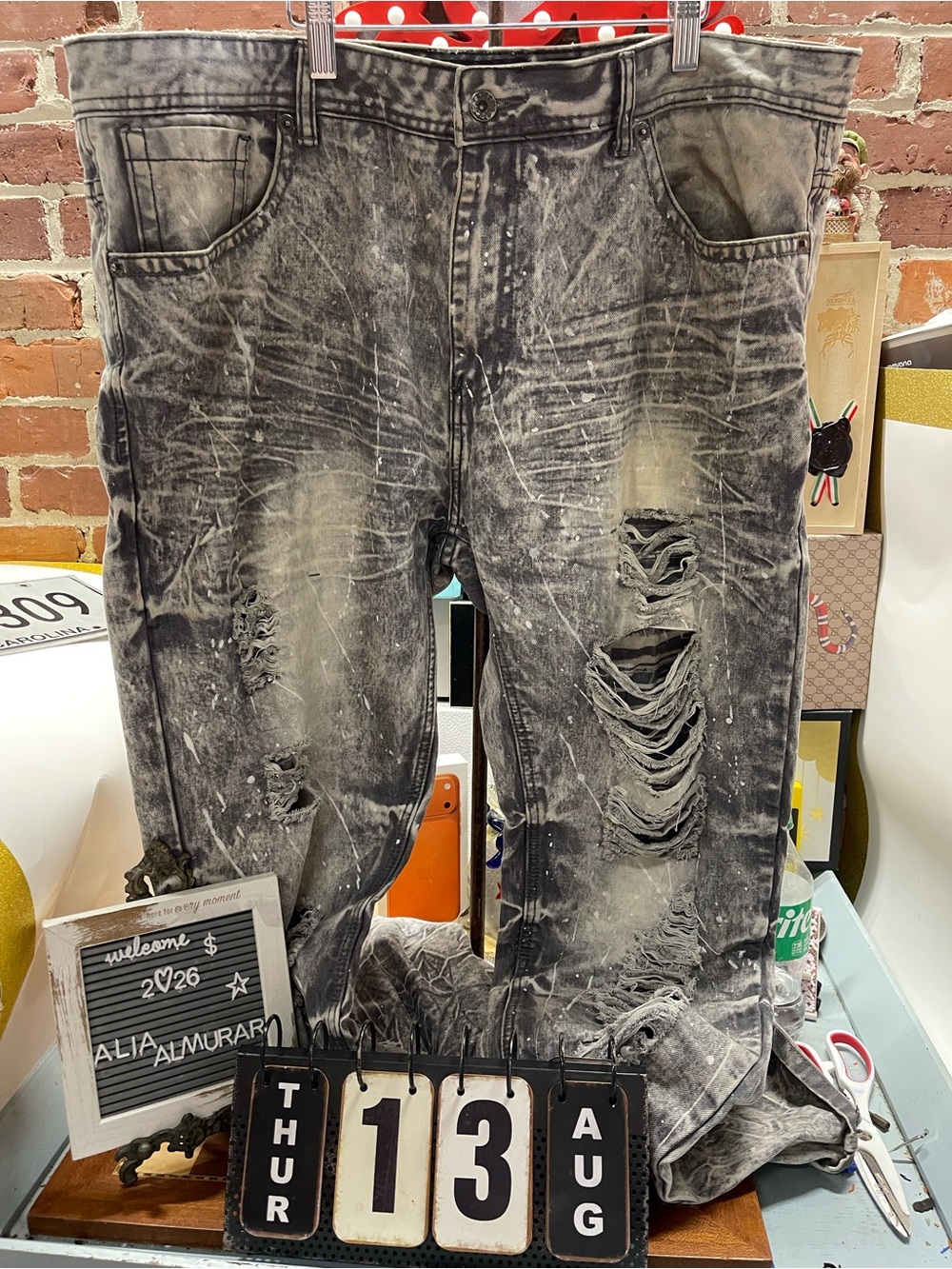 stylish, faded grey stonewashed men's denim jeans featuring heavy distressing, r